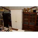 A white painted pine two door wardrobe