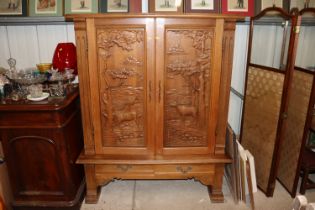 A German oak cupboard with carved decoration fitte