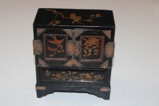 An Oriental black lacquered jewellery cabinet