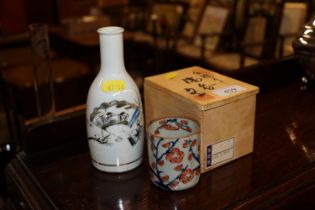 A small oriental decorated vase and a boxed orient