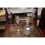 Two decanters and stoppers and a pair of glass can