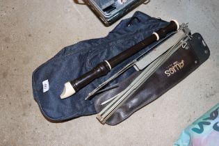 A recorder, sheet music stand and carry bag