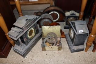 A quantity of various clocks and a tin of spare pa