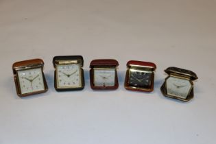 A box of vintage travelling alarm clocks