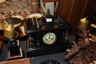 A late Victorian slate and rouge marble mantle clock and matching garnitures