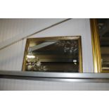 A gilt framed bevelled edged wall mirror with deco