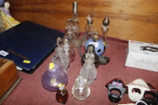 A perfume atomiser and a collection of scent bottl