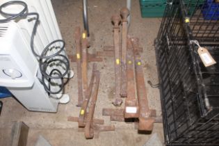 Four pairs of angled cast iron fire dogs