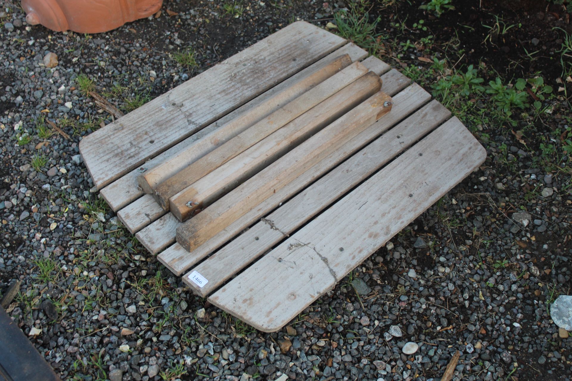 A small wooden garden table, dismantled