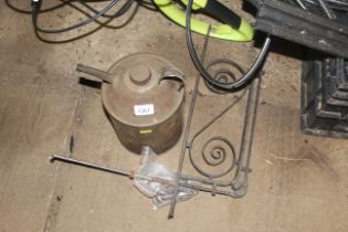 A wrought iron bell pull and a paraffin can