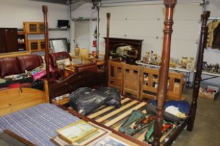 A mahogany four poster bed with curtains