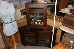 A oak and leaded glazed tv stand and an oak and le