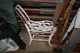 A pair of white painted cast iron bench ends