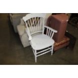 A white painted spindle back elbow chair