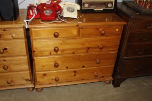 A modern pine chest fitted two short over three lo