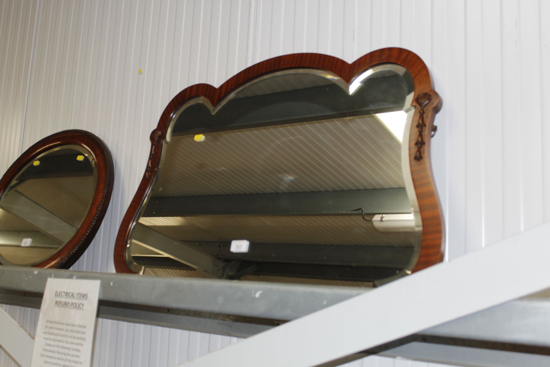 A mahogany framed and bevel edged wall mirror