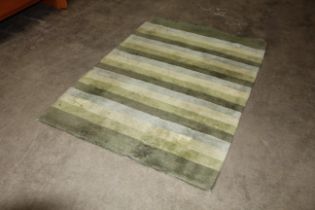 An approx. 5'7" x 4' green wool rug AF