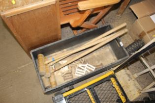 A box containing four croquet mallets (one AF) cro