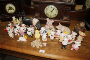 A collection of pig ornaments and Nat West piggy b