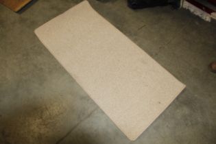 An approx. 4'7" x 2'3" modern wool rug