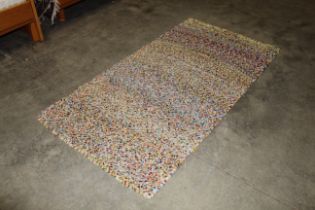An approx. 6'7" x 3'4" multi coloured wool rug