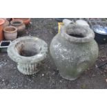 A large concrete twin handled garden urn and a con