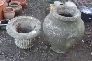 A large concrete twin handled garden urn and a con