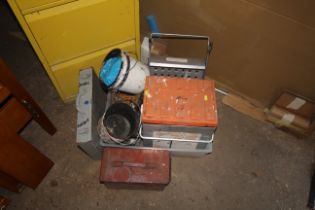 A quantity of paint buckets, a BrushMate paintbrush storage box