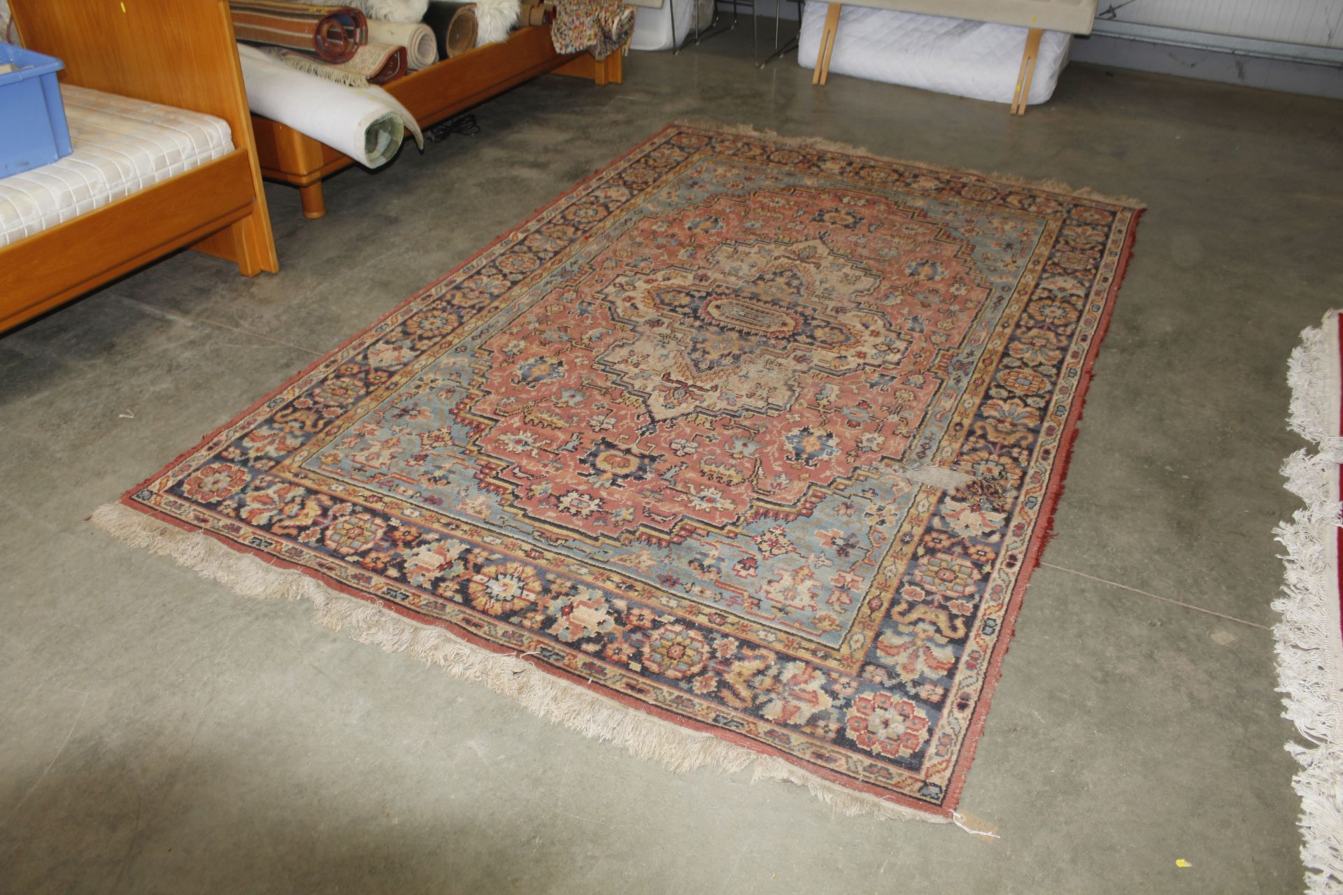 An approx. 10' x 6'3" floral patterned wool rug AF