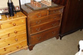 An oak chest fitted two short over three long draw