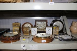 A collection of various clocks and two barometers