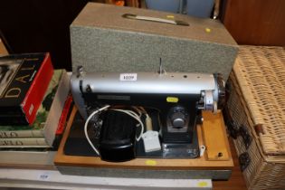 A universal electric sewing machine in fitted case