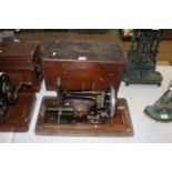 A hand operated sewing machine in fitted wooden ca