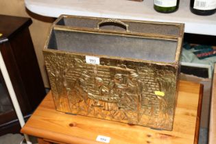 An brass embossed paper rack with tavern scene des