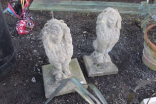 A pair of concrete lion ornaments, one base AF