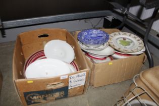 Two boxes of various patterned dinnerware to inclu