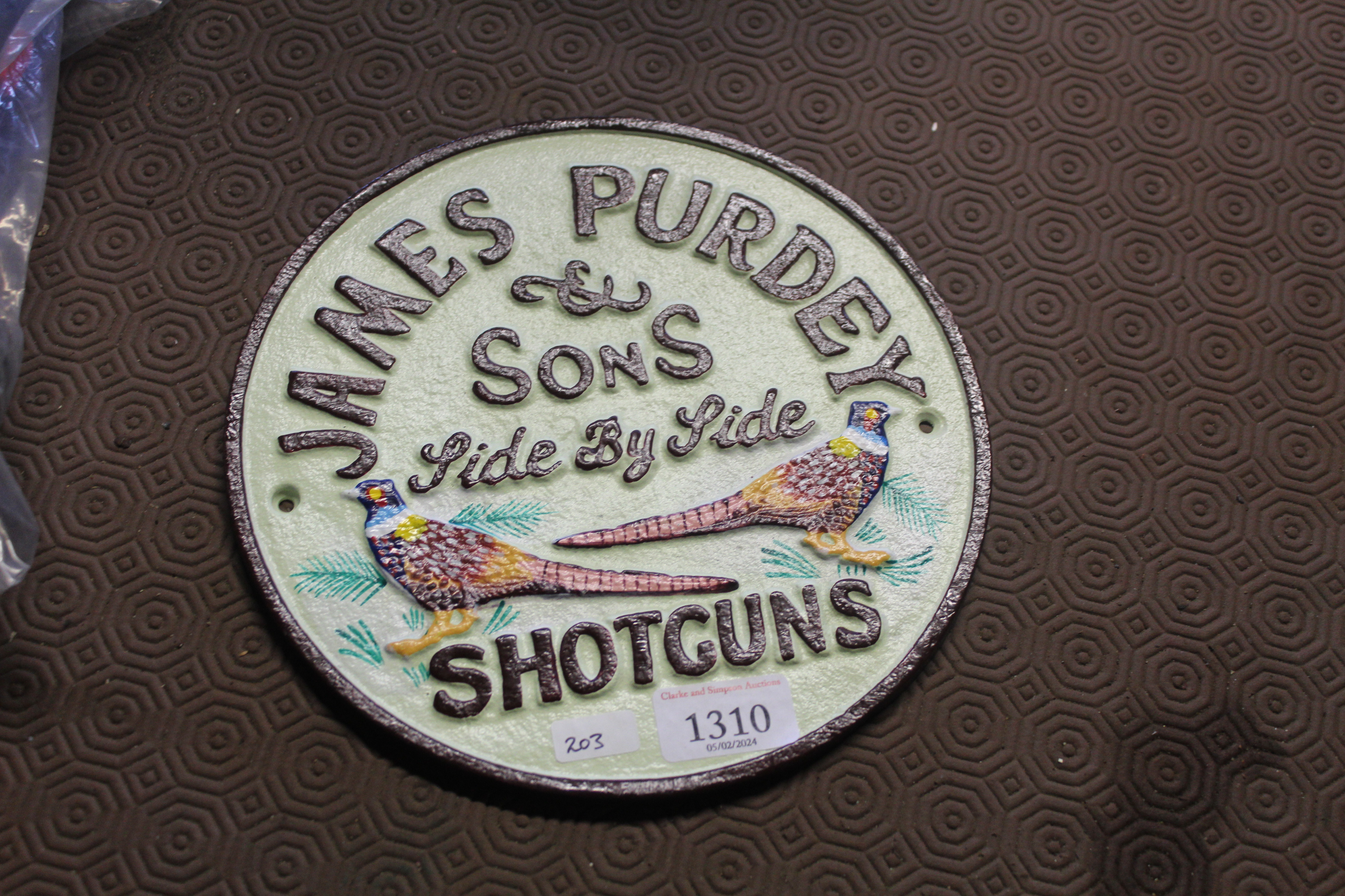 A circular cast iron sign "James Purdy & Sons" (20