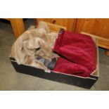 A box containing a simulated fur coat and a pair o