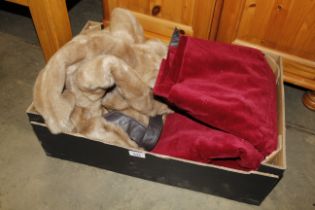 A box containing a simulated fur coat and a pair o