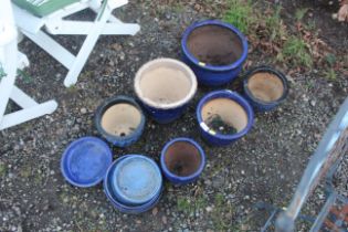A quantity of various sized blue glazed plant pots