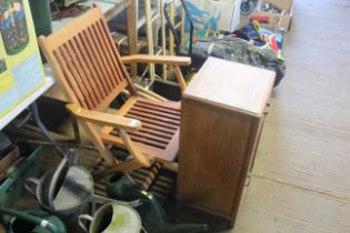 A wooden folding chair and a small wooden cabinet