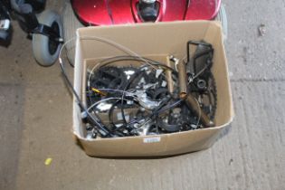 A box containing a quantity of bicycle parts to in