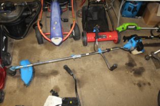 An SGS 52cc petrol strimmer with harness and instr