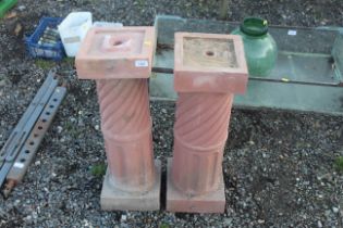 A pair of plant pot stands in the form of columns