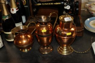 Three brass and copper jugs