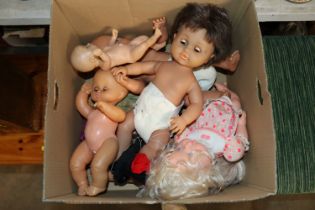 A box of various dolls