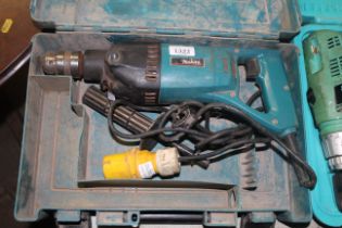 A Makita 8406 110 volt electric drill in fitted pl