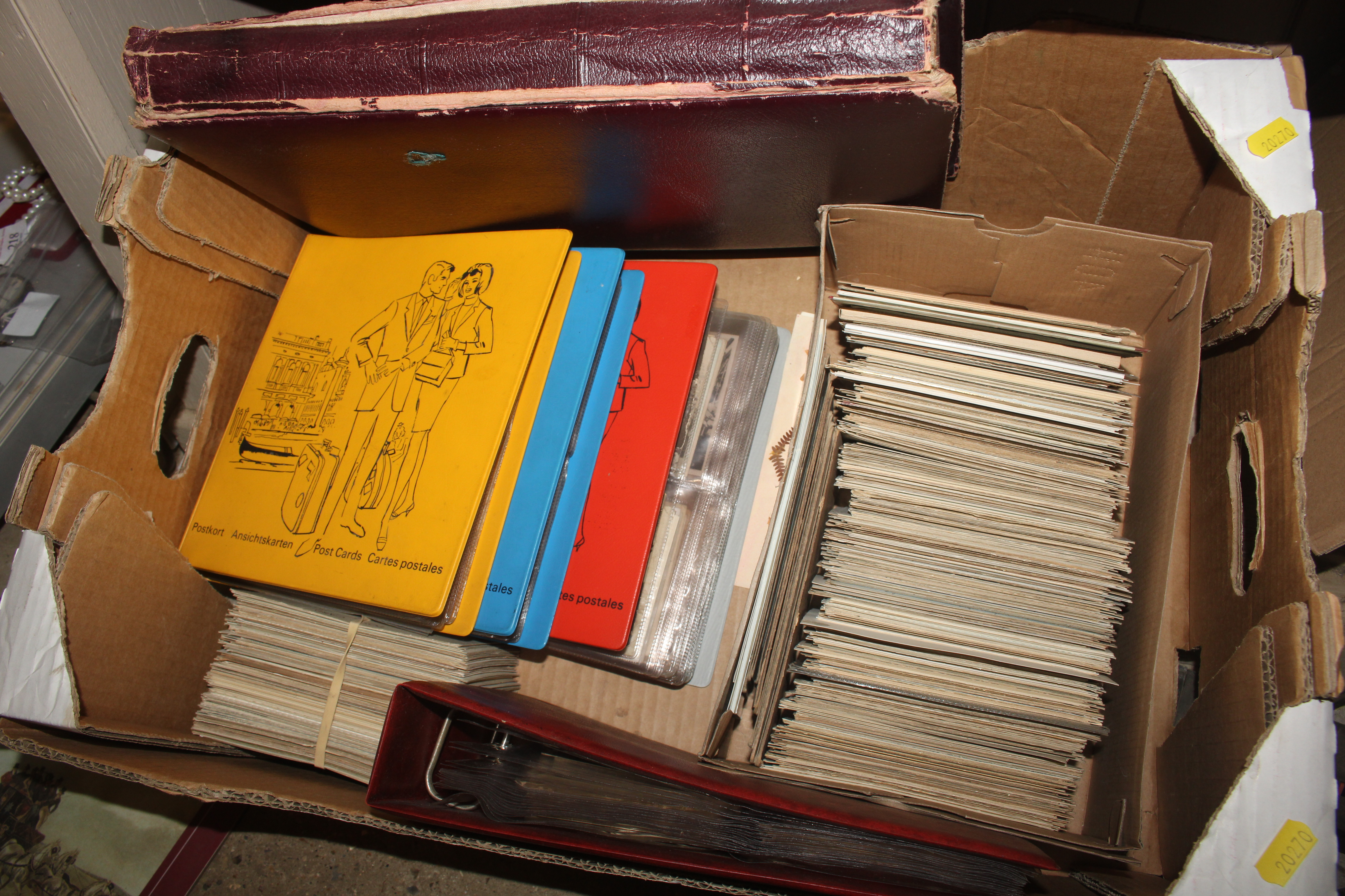 A box containing five postcard albums and contents