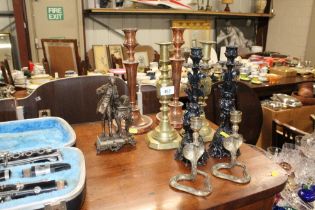 Four pairs of various candlesticks and a figural d