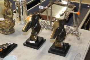 A pair of greyhound ornaments on stepped bases